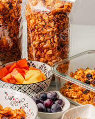 Healthy breakfast ingredients with handmade granola and fruits mango, papaya and grapes