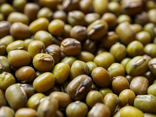 Mung beans on a light background, emphasizing their shape and texture, create a feeling of freshness and naturalness.