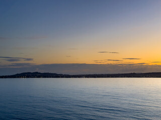 Katakolo, Greece - July 4, 2024: Sunrise over the mainland along the Ionian Sea coast. Some...
