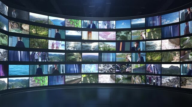 Big curved video wall showing multiple footage clips with question marks