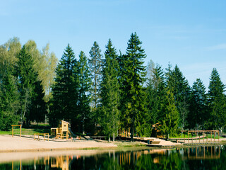 modern wooden playground on the lake shore