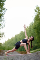Dedicated yogi executes a challenging deep lunge, twisting the upper body while extending one arm...