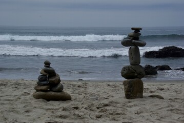 Balancing stones on beach