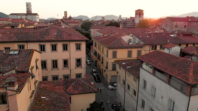 Aerial sunset evening view of famous Lucca city, known for its intact Renaissance-era city walls and well preserved historic center. Province of Lucca, Tuscany, Italy.