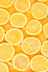 A slices of fresh juicy yellow lemons.  Texture background, pattern.