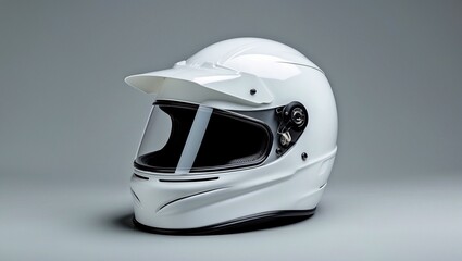 Glossy white racing helmet on light grey surface