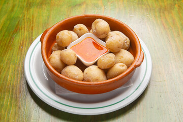 Traditional canarian wrinkled potatoes with mojo picón sauce served in a ceramic bowl