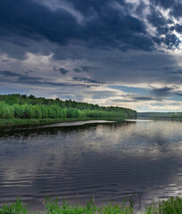 Calm lake with a cloudy sky in the background