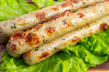 Grilled sausages served on fresh lettuce with a hearty texture