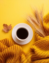 Cozy autumn composition featuring a yellow knitted blanket, a cup of coffee on a vibrant yellow background. Perfect for cozy fall and winter concepts. Top-view flat-lay style. Ideal for warm autumn