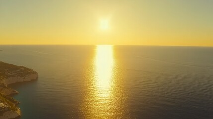 Obraz premium Golden sunset reflection over tranquil ocean waters coastal landscape aerial view nature beauty