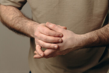 Fototapeta premium man suffers from chronic arthritis. pain in the joints of the fingers. inflammation of the joints, which can be caused by osteoarthritis wear of cartilage or rheumatoid arthritis. hands close-up