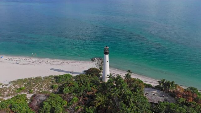 Drone footage of Key Biscayne Lighthouse in shoreline with seascape and green vegetation