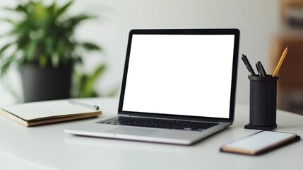 laptop computer with a blank white screen on a wooden desk. 