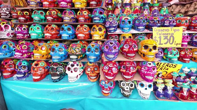 A table full of skulls and skeletons with a sign that says "SALEROS OFERTA" on it