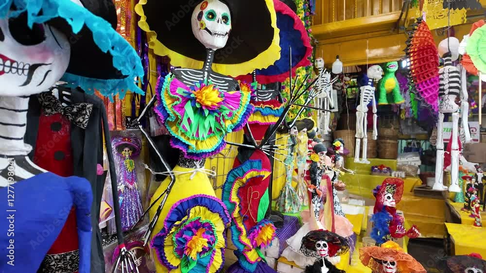 Aufkleber a display of skeletons and skeletons with flowers on them. the skeletons are dressed in colorful clo