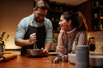 Couple enjoying cooking together in modern kitchen