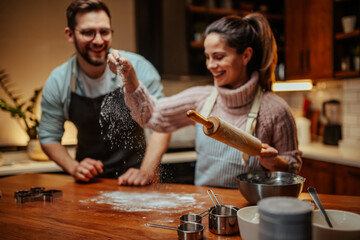 Couple enjoying baking together in cozy kitchen