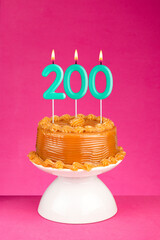 Birthday cake with number 200 candle - Number of followers or likes.