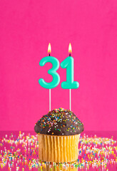 Birthday card with cupcake and number 31 candle - Pink background.