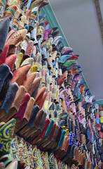 Vertical view Slippers or sandals of many colors hung from street stalls