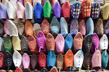 Front view of Slippers or sandals of many colors hung from street stalls