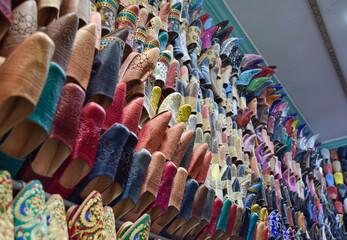 Side view Slippers or sandals of many colors hung from street stalls in Marrakech's souk