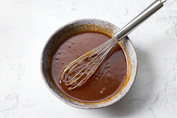 bowl of homemade hoisin sauce on white kitchen table