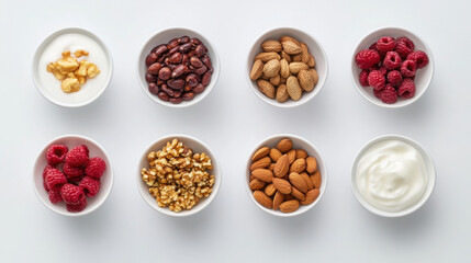 Obraz premium Assorted healthy snacks featuring nuts, berries, and yogurt in minimalist studio setting