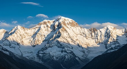 Fototapeta premium Majestic mountain range with snow-capped peaks and clear blue sky