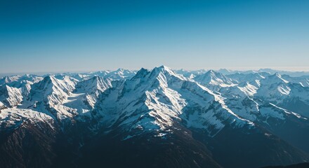 Majestic mountain range with snow-capped peaks and clear blue sky