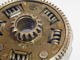 A 45 degree angled view of a driven gear clutch mechanism with internal cogs on a white background, showcasing precision engineering and industrial design.