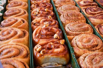 Delicious tahini and cheese buns fresh out of the oven. Cheese buns topped with cherry tomatoes and dill. pastry art. Pastry products.