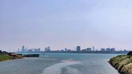 View of Phnom Penh skyline from Mekong River. Skyscrapers in the background. Cambodia. South-East Asia