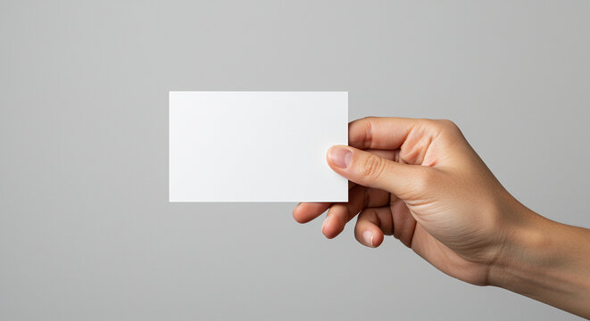 Business card in hand close up shot. Hand holding business card with hand gesture. Business card held by hand