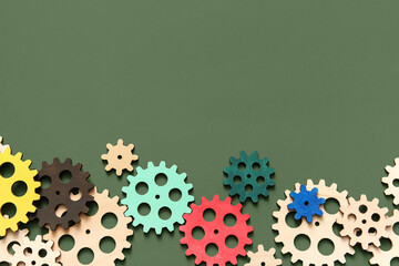 Wooden gears on green background