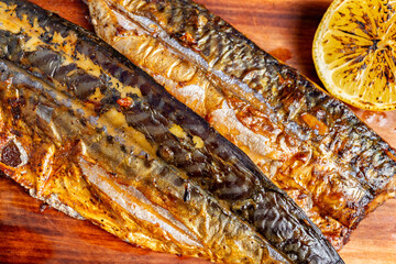 Grilled mackerel fillets served with charred lemon slices