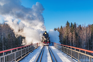 Retro train moves above the river.