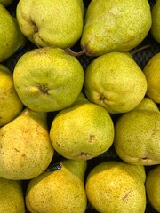 yellow green pears on market stall