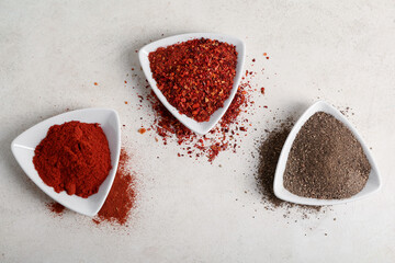 Plates with fresh spices on light background