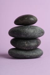 Stack of rocks on lilac background. Harmony and life balance