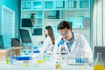 Asian male and female scientists work together in the research laboratory.