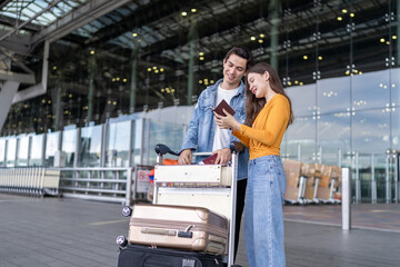 Fototapeta premium Asian young couple passenger standing outdoors of airport terminal.