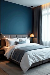 Soft bed linens, deep blue accent wall, sleek modern design, cozy bed, plush, sophisticated