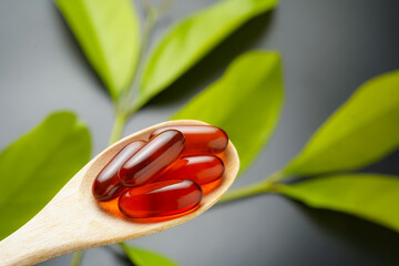 wooden spoon with soft gels, Fish oil capsules, omega 3, omega 9, vitamin D, vitamin E