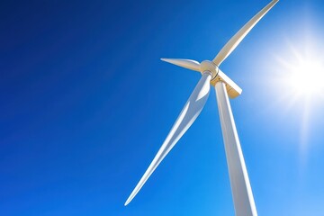 Fototapeta premium Majestic Wind Turbine Soaring Against a Vibrant Blue Sky Capturing Renewable Energy and Sustainable Future with a Low Angle and Bright Sunlight