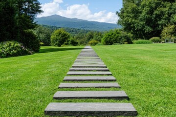 Serene garden path leading to distant mountains under a bright blue sky lush green lawn and trees landscape design stone steps nature escape