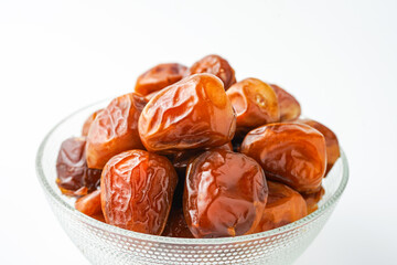 Dates fruit sukari or kurma sukari, in bowl isolated on white background