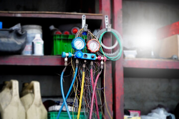 Car air conditioning refrigerant gauge set in the garage,Car A/C testing equipment