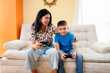Mother and son having fun playing video games at home